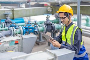 Engineer monitoring factory systems with tablet 